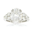 Platinum and Diamond Three Stone Style Engagement Ring, with 5.06ct Oval Diamond Center