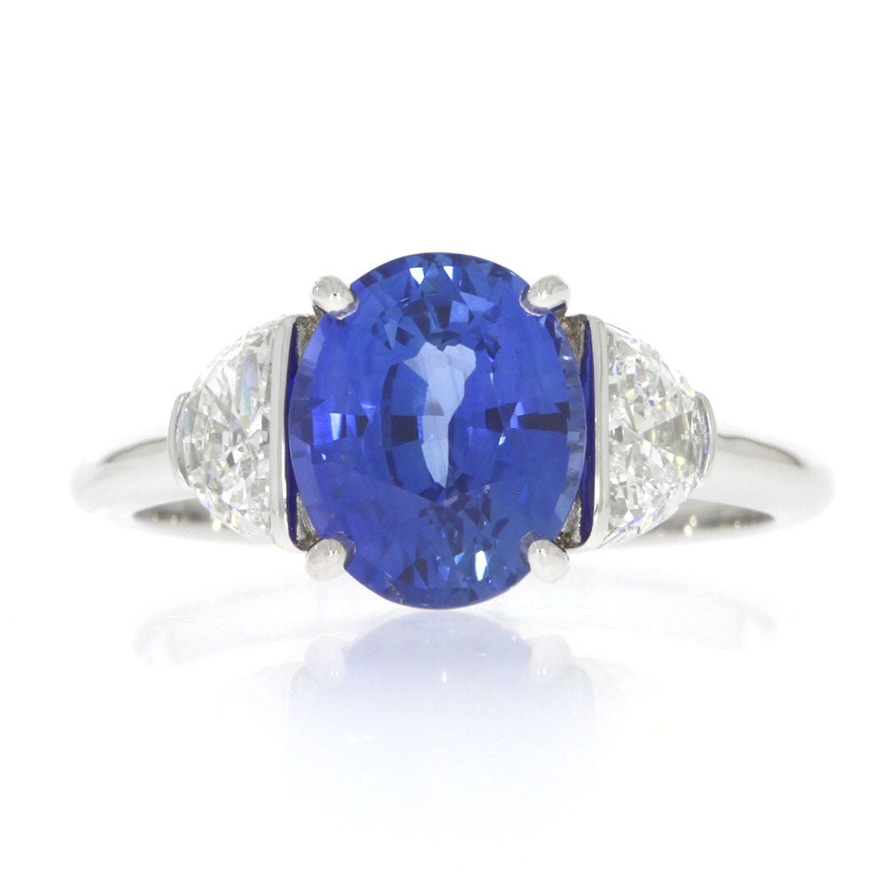 18 Karat White Gold And Oval Blue Sapphire And Half Moons Brilliant Diamonds Three Stone Ring