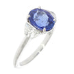 18 Karat White Gold And Oval Blue Sapphire And Half Moons Brilliant Diamonds Three Stone Ring