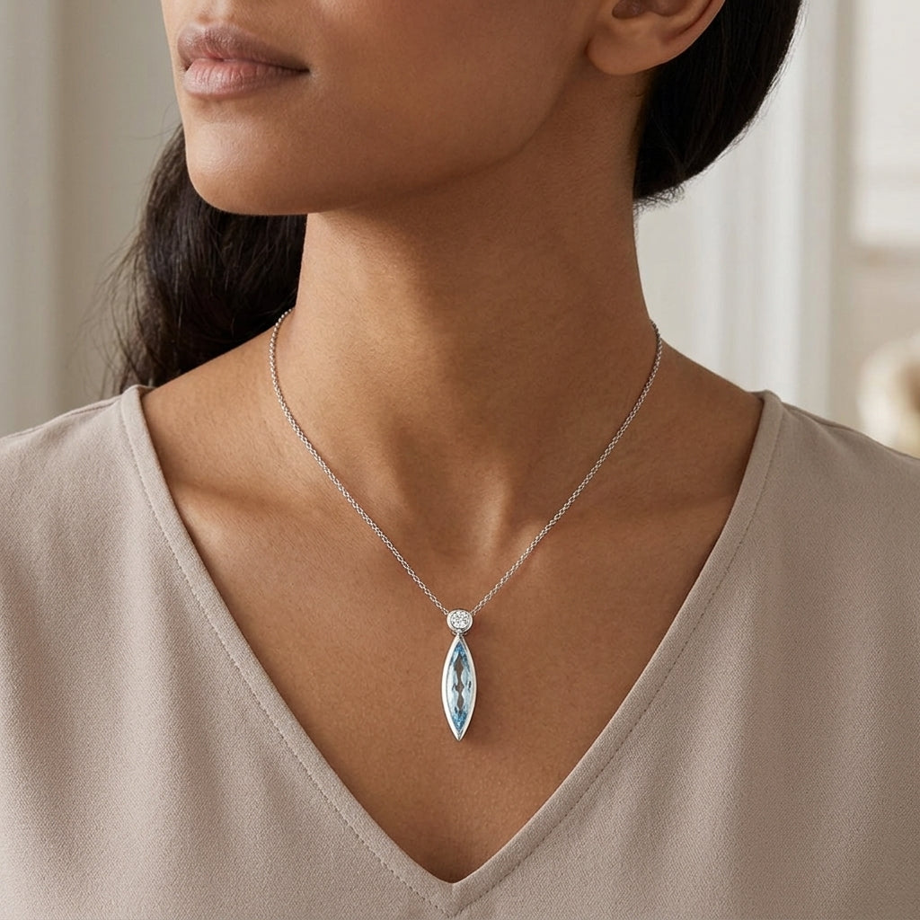 Sterling Silver Bezel Set Marquise Blue Topaz Pendant, with White Sapphire Accented Bail