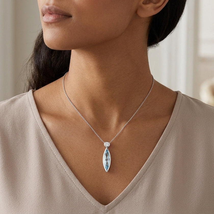 Sterling Silver Bezel Set Marquise Blue Topaz Pendant, with White Sapphire Accented Bail