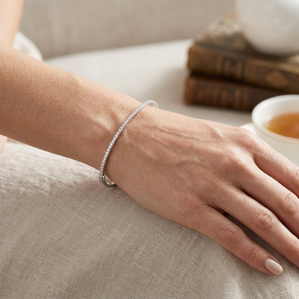 A persons wrist wearing a single diamond bracelet 