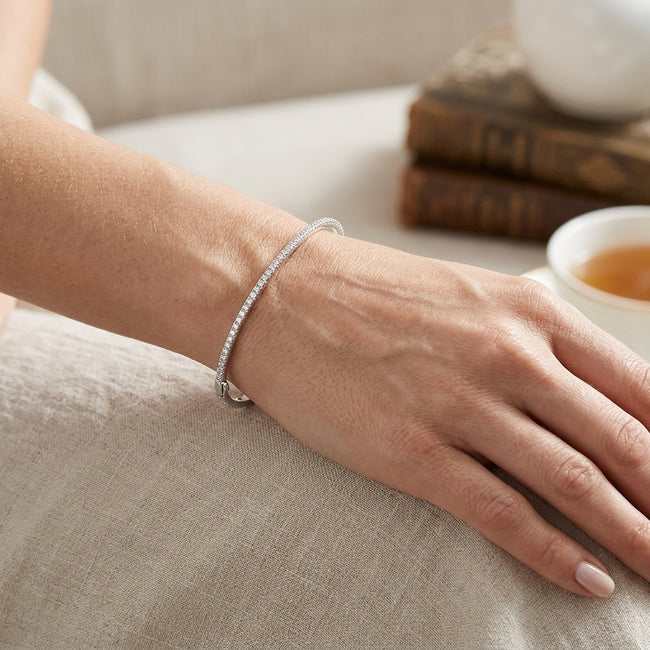 A persons wrist wearing a single diamond bracelet 